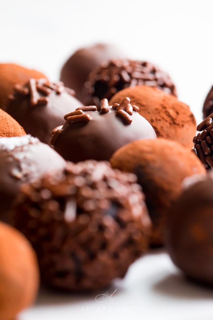 Several chocolate truffles shot from the side close up