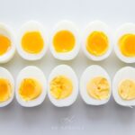 Ten eggs cut in half showing their differently cooked yolks