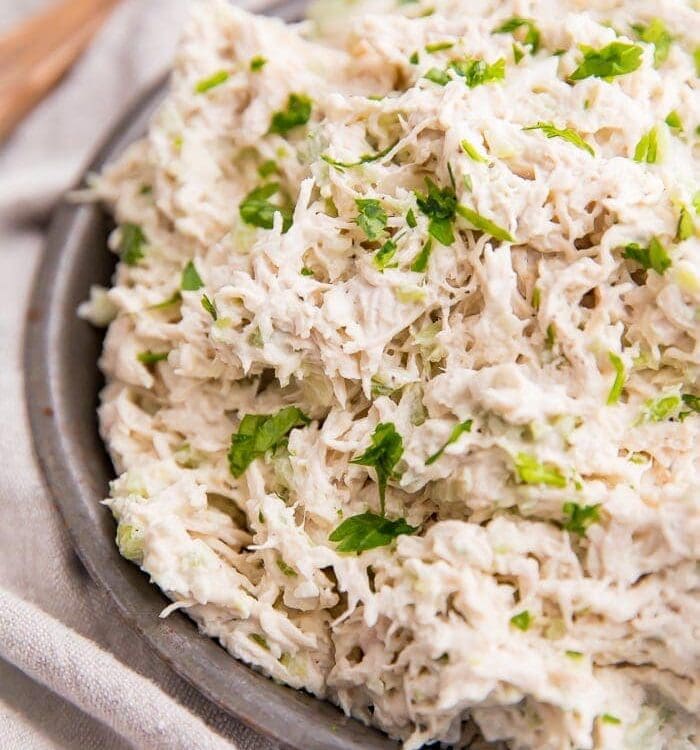 Shredded chicken salad on an antique metal bowl