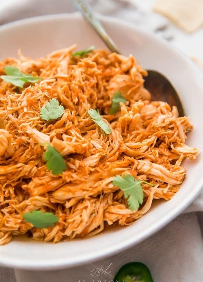Shredded Mexican chicken in a white bowl