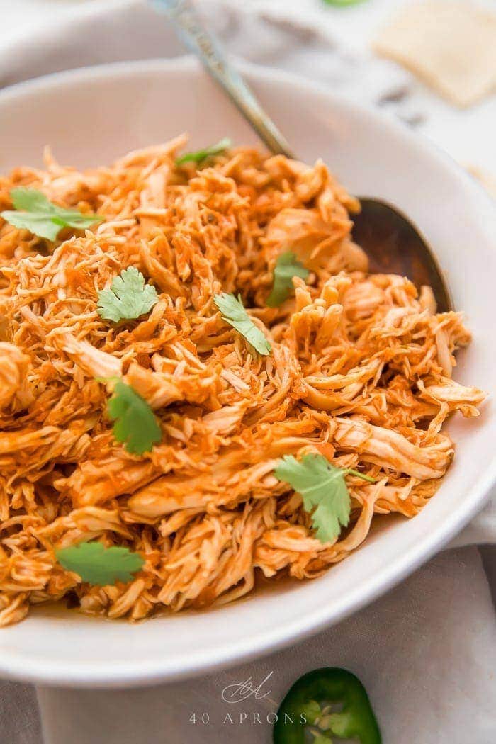 Shredded Mexican chicken in a white bowl