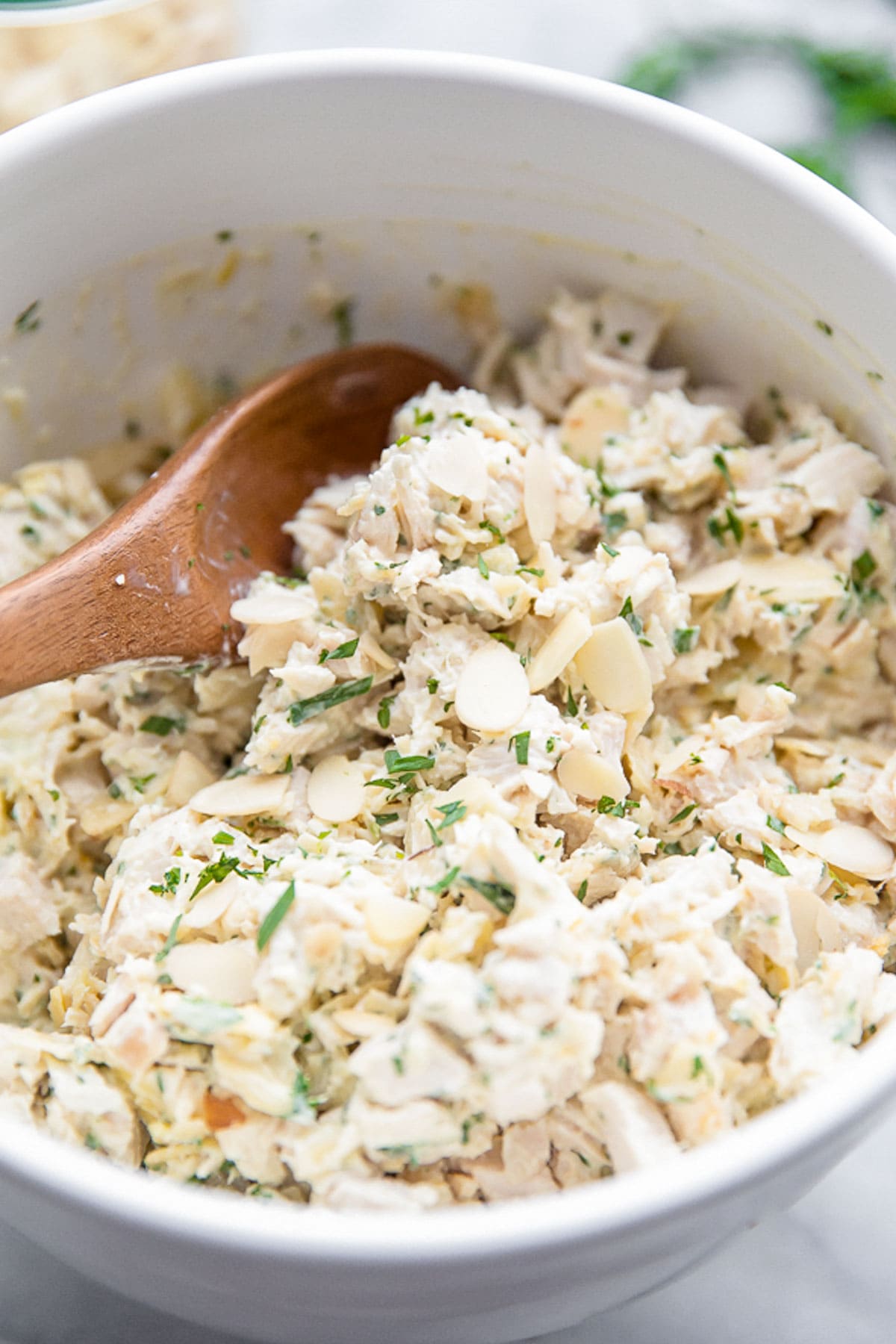 A bowl of tarragon chicken salad with slivered almonds.
