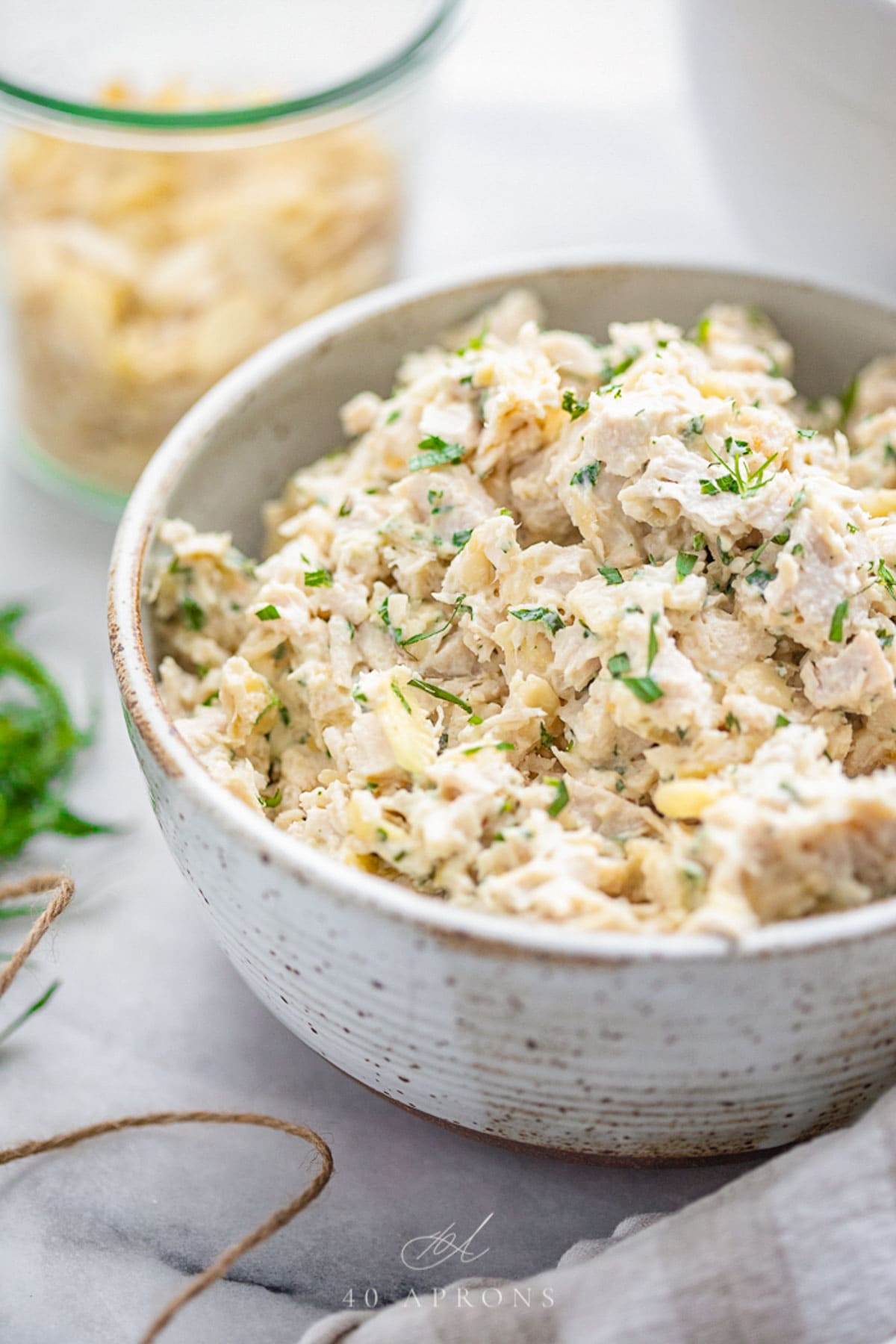 A bowl of tarragon chicken salad with slivered almonds.