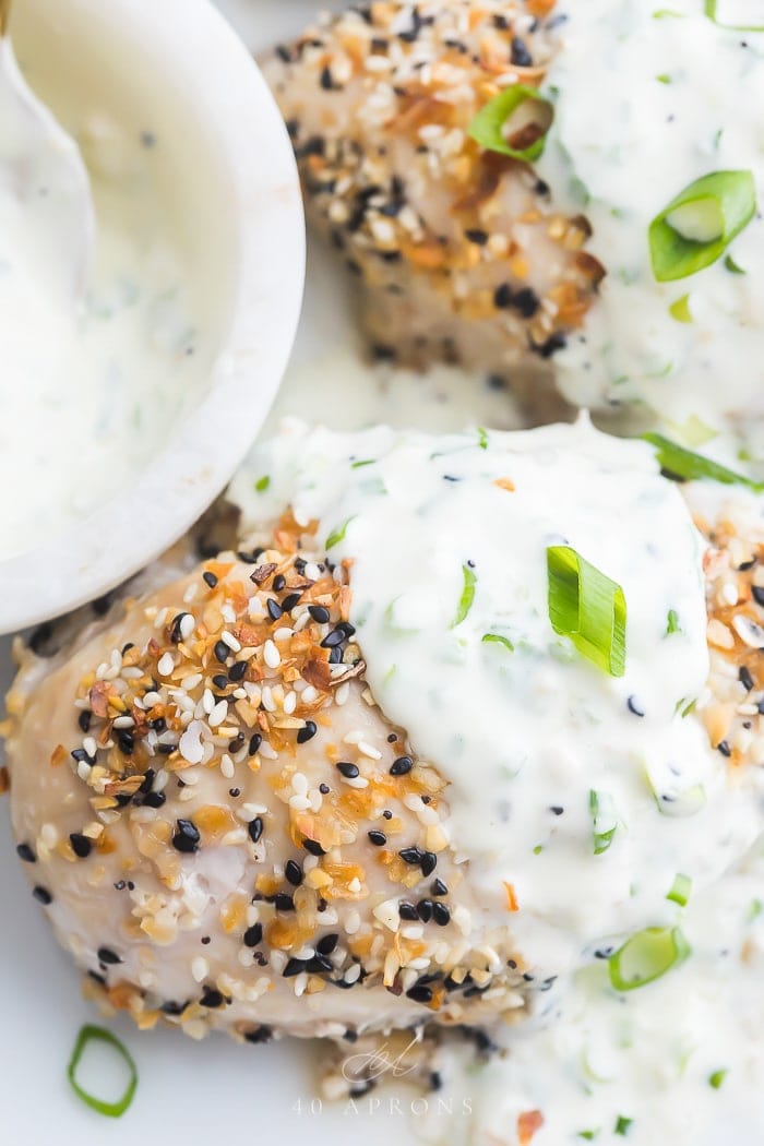 Close up of chicken breasts coated in everything bagel seasoning with cream cheese sauce