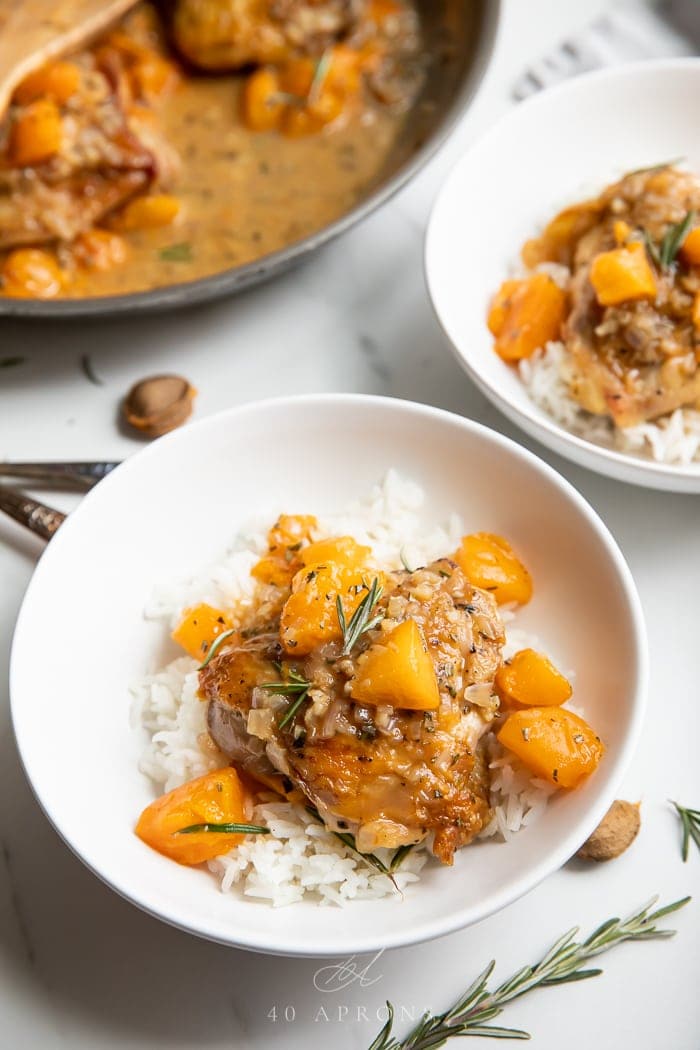 Apricot chicken over white rice in two white bowls