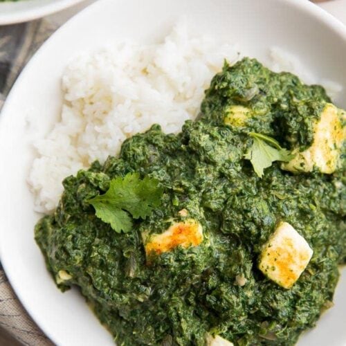 A bowl of palak paneer over rice