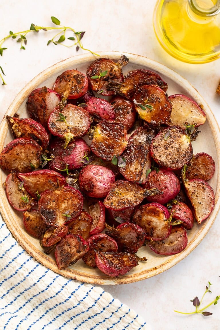 A plate of roasted radishes drenched in garlic browned butter.
