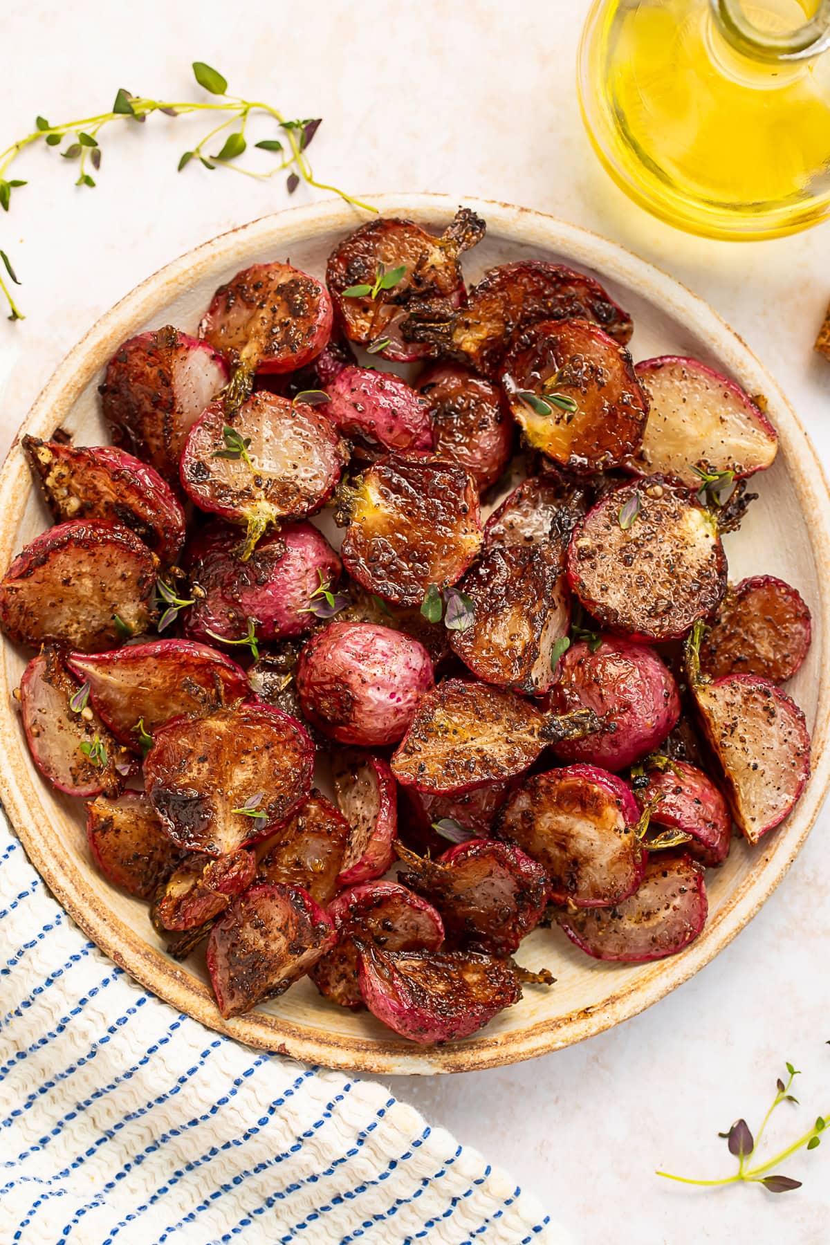 A plate of roasted radishes drenched in garlic browned butter.