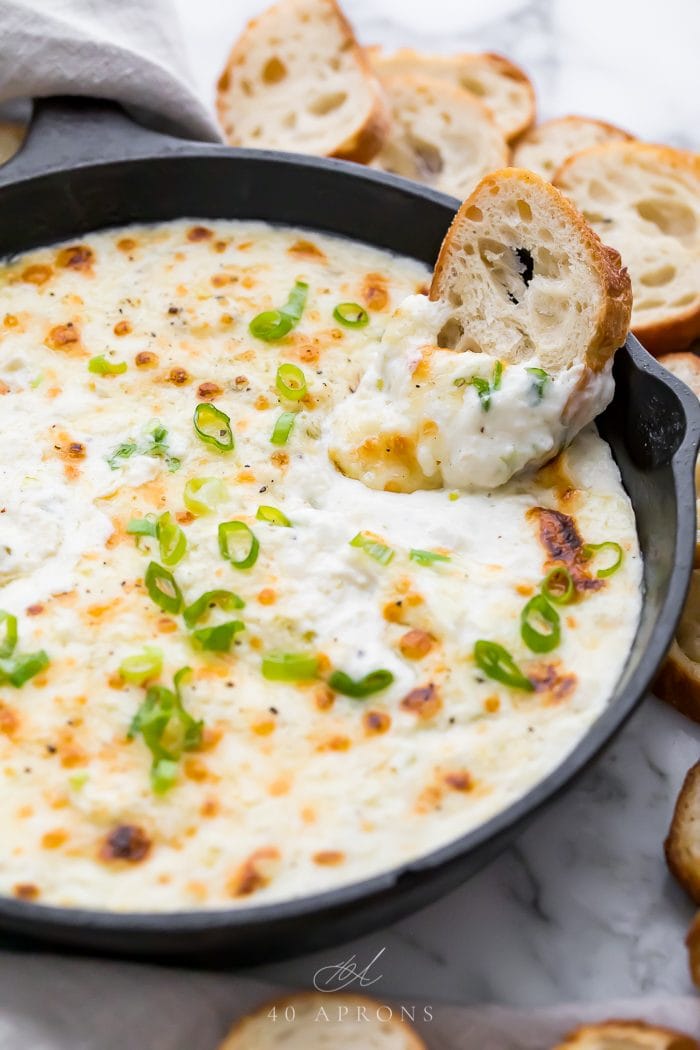 A piece of crostini in the baked crab dip