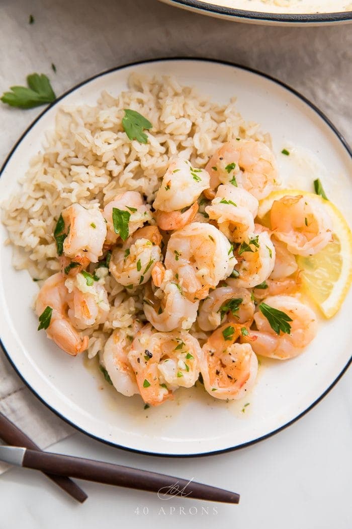 A plate of lemon garlic shrimp over rice