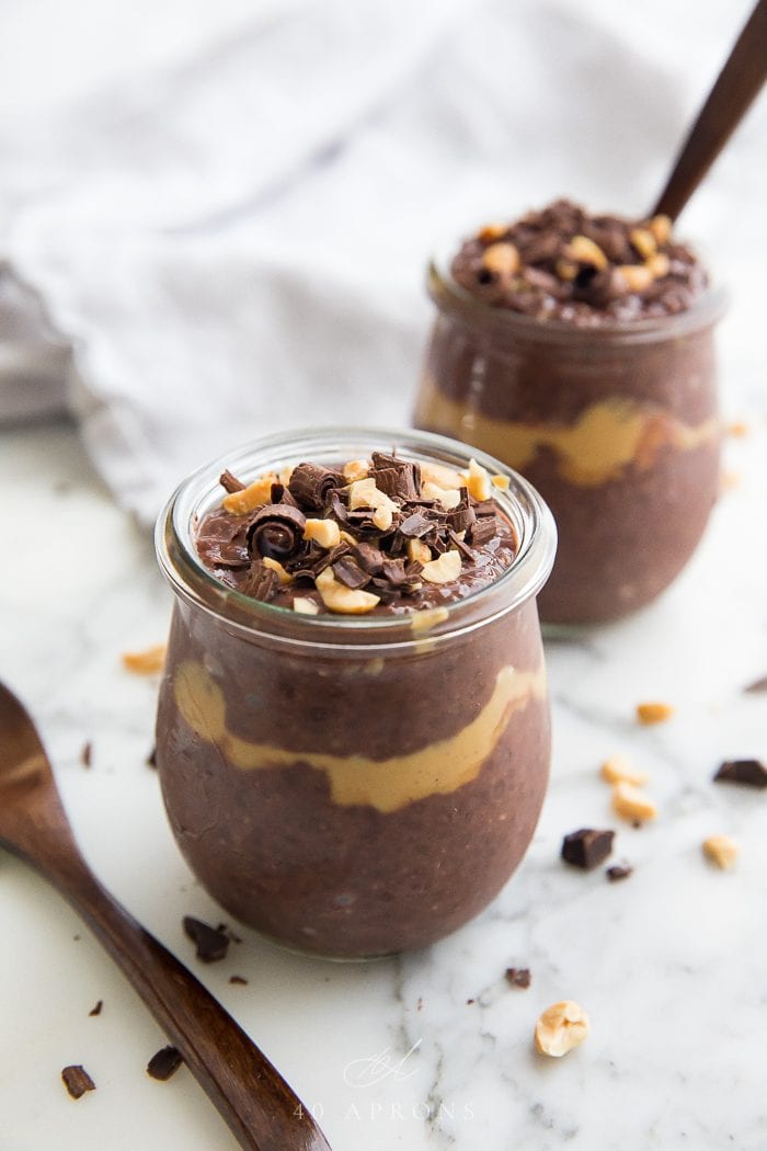 Two jars of pudding on a marble work surface