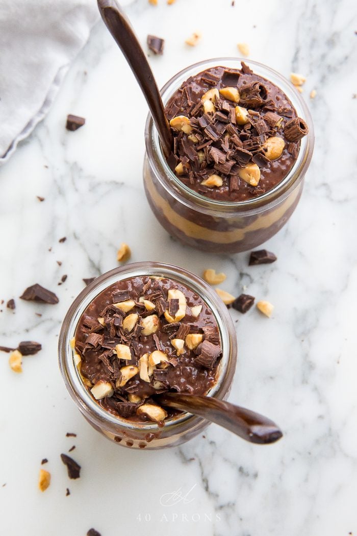 Top shot of two choclate chia puddings with spoons in them