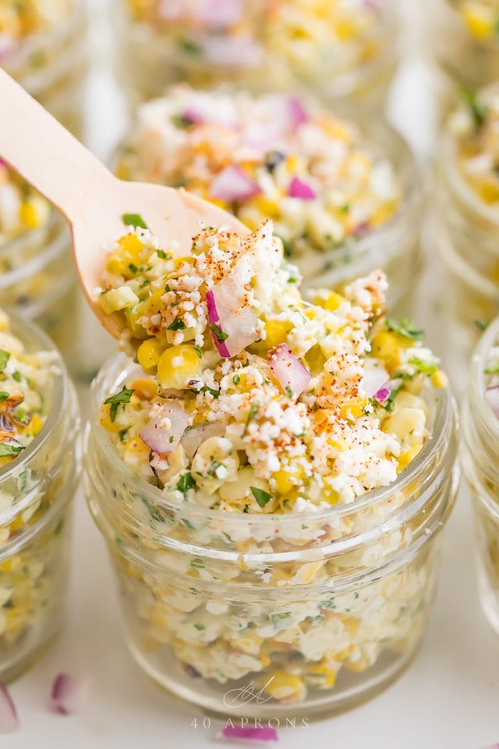 mexican street corn salad being lifted up on a spoon