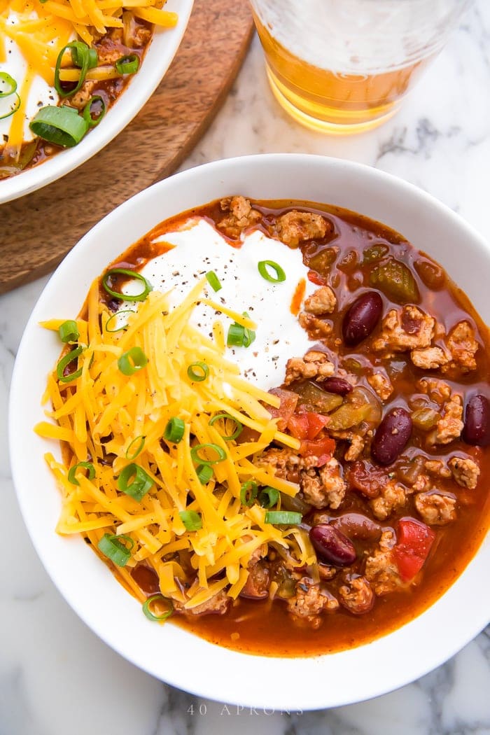 Top shot of slow cooker turkey chili served with toppings