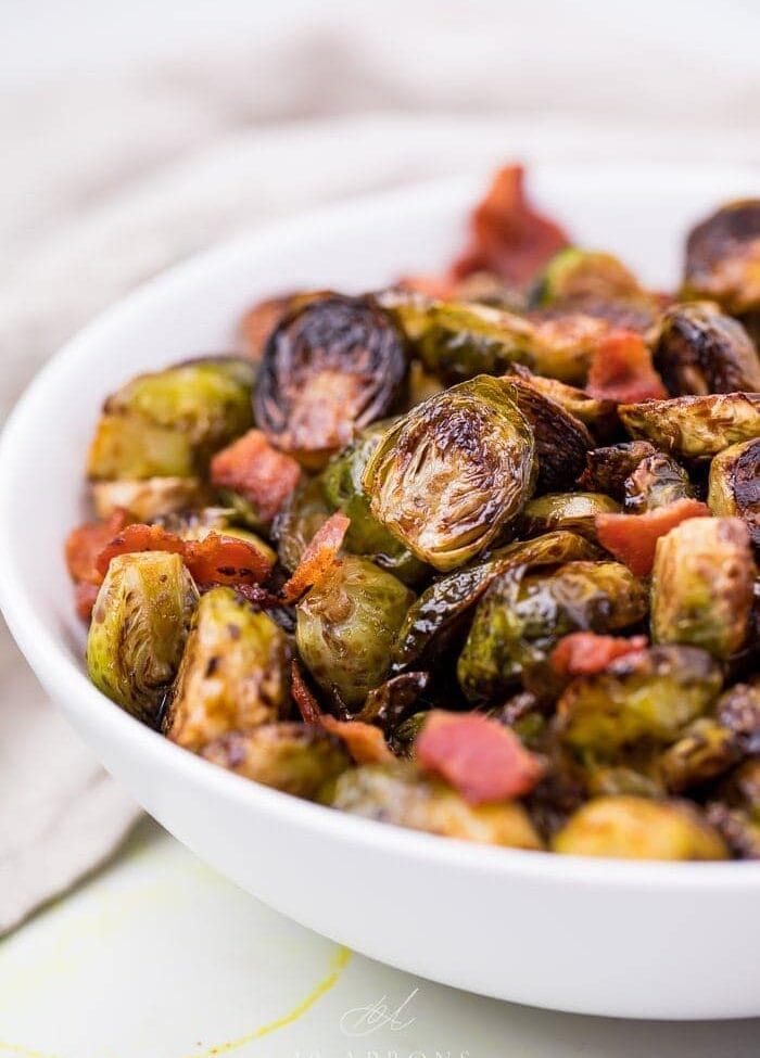 Balsamic Brussels sprouts and bacon in a white dish