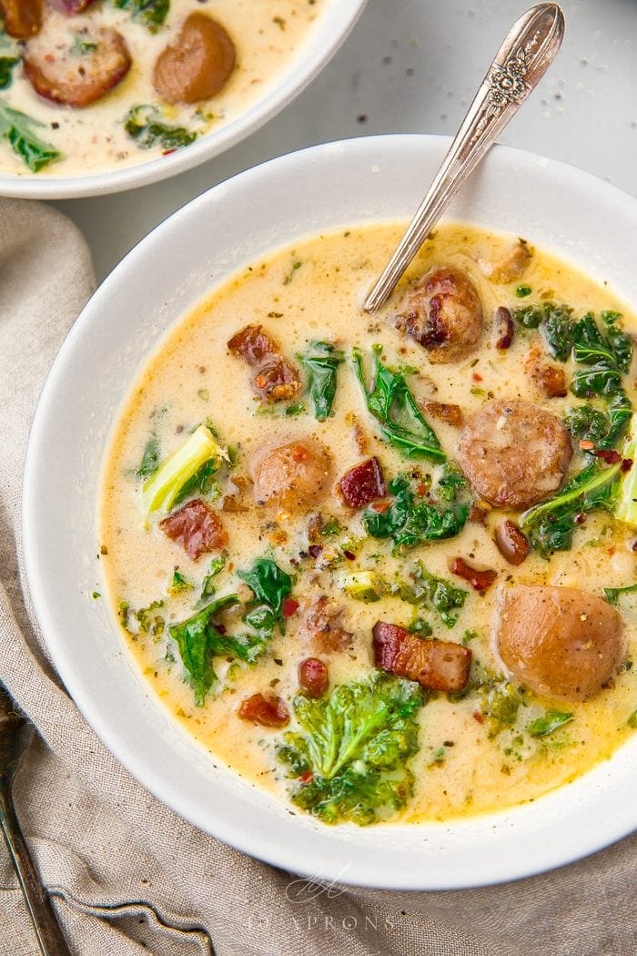 Crockpot Zuppa Toscana served in a white bowl with a spoon