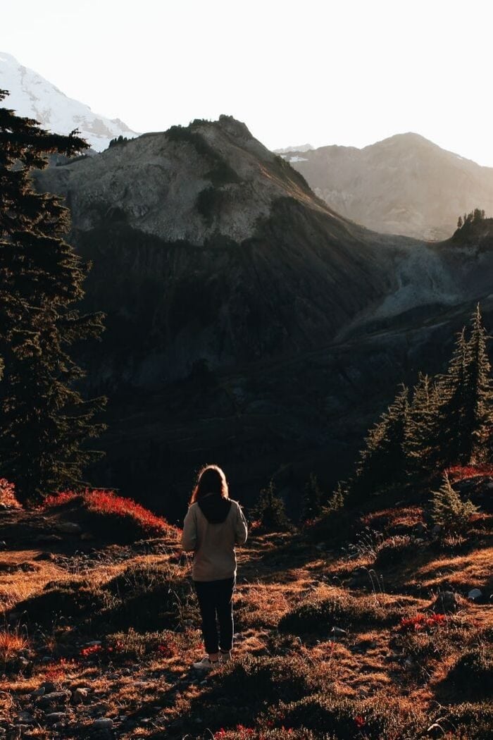 a woman hiking in an autumnal landscape