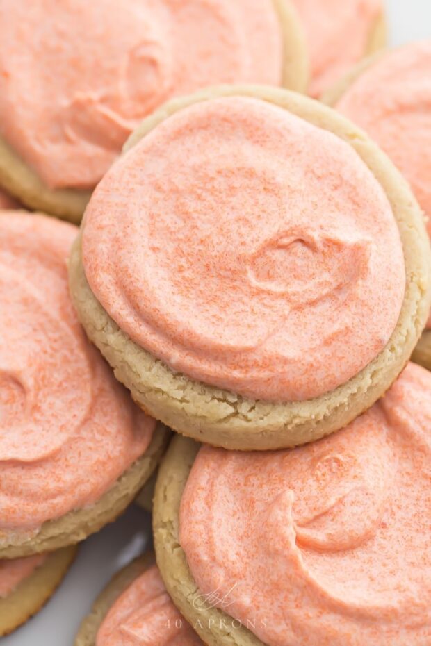 Pink iced cookies stacked on top of eachother