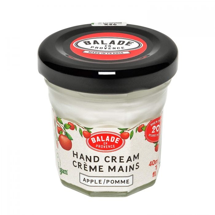 a small jar with apple scented hand cream for dry hands 