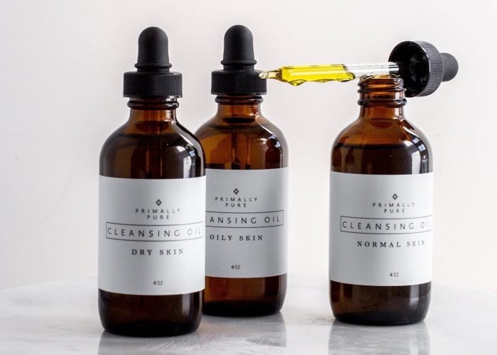 three bottles of Primally Pure cleansing oil against a white background