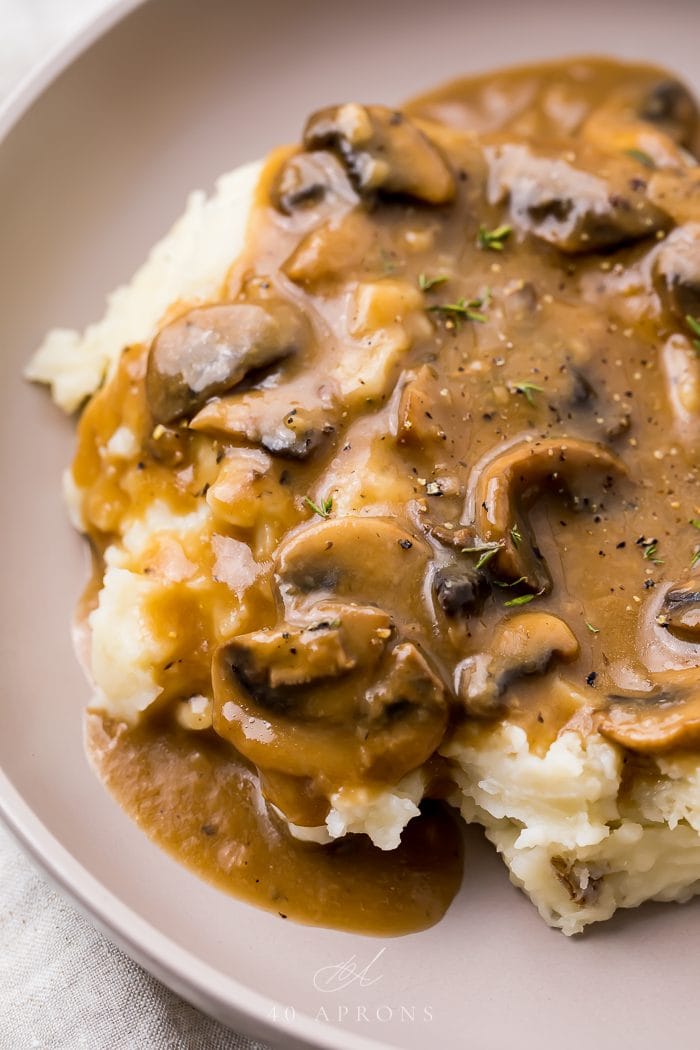 Mushroom gravy and nashed potatoes in a white bowl
