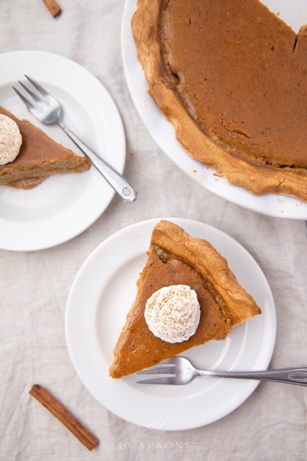 A slice of paleo pumpkin pie topped with whipped cream