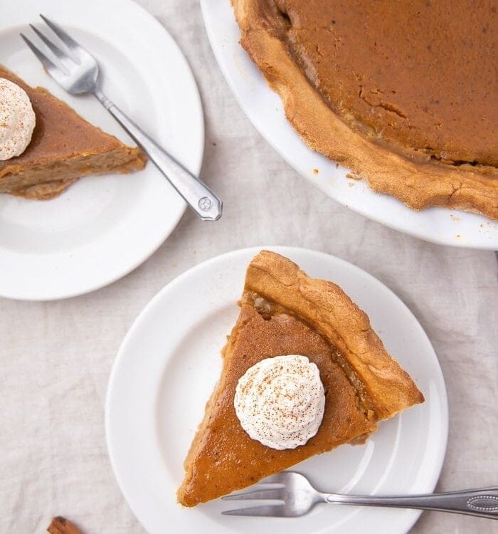 A slice of paleo pumpkin pie topped with whipped cream