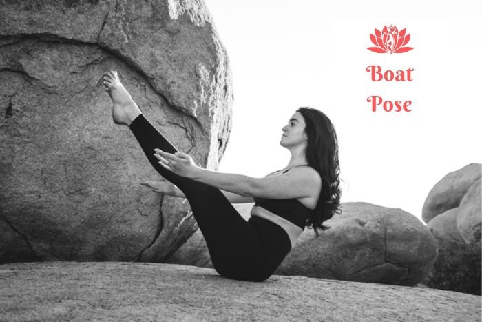 a woman on a rock holding the yoga boat pose 