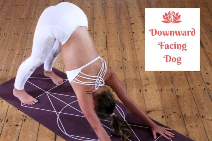 a woman entering the detox yoga position of downward dog