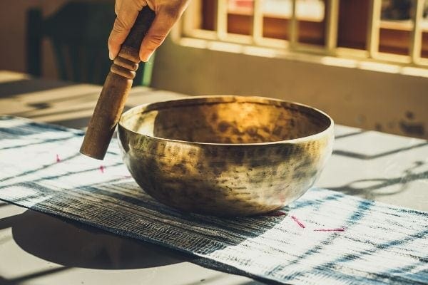 side view of a golden Tibetian singing bowl  on a table