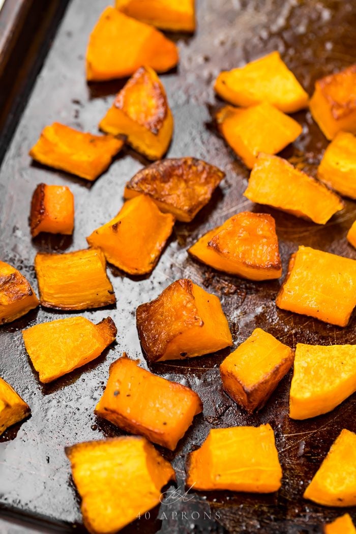 Cubes of butternut squash on a baking sheet