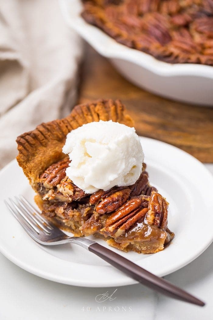 A slice of pecan pie with whipped cream