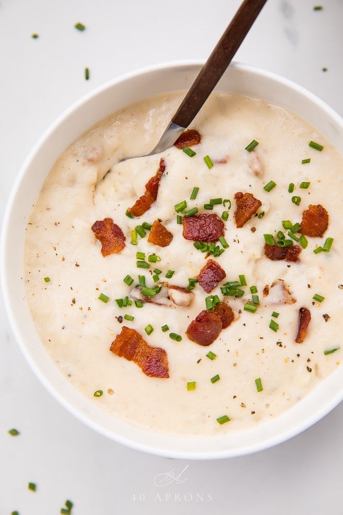 A spoon in a bowl of whole30 potato soup