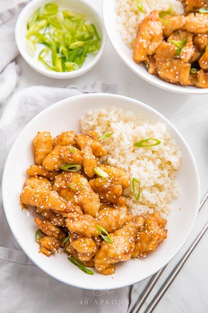 Whole30 sesame chicken over cauliflower rice in a bowl