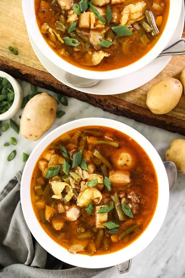 Hamburger soup served in two white bowls