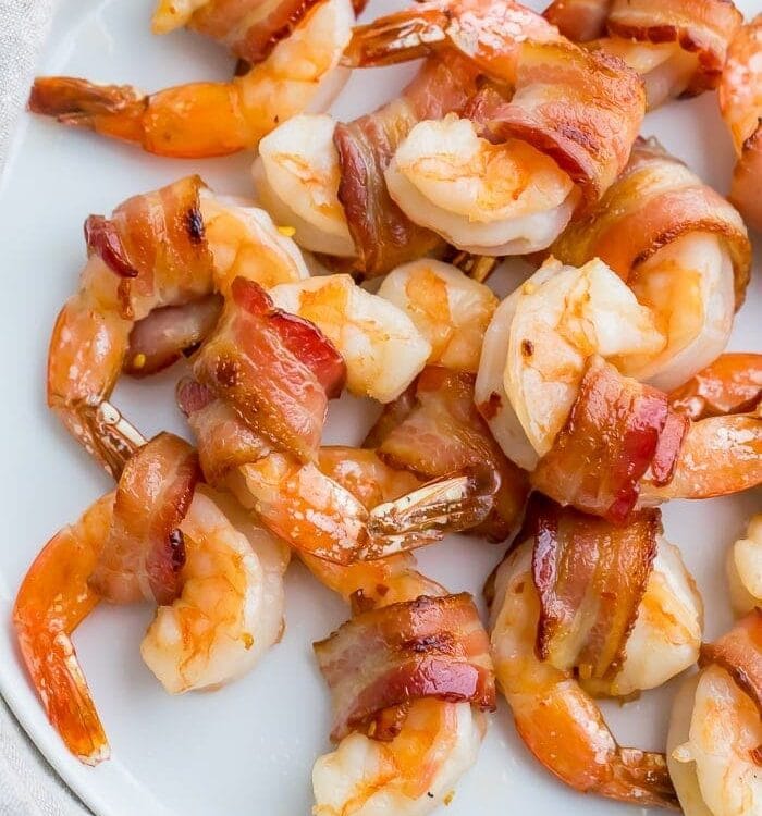 Bacon wrapped shrimp on a white plate
