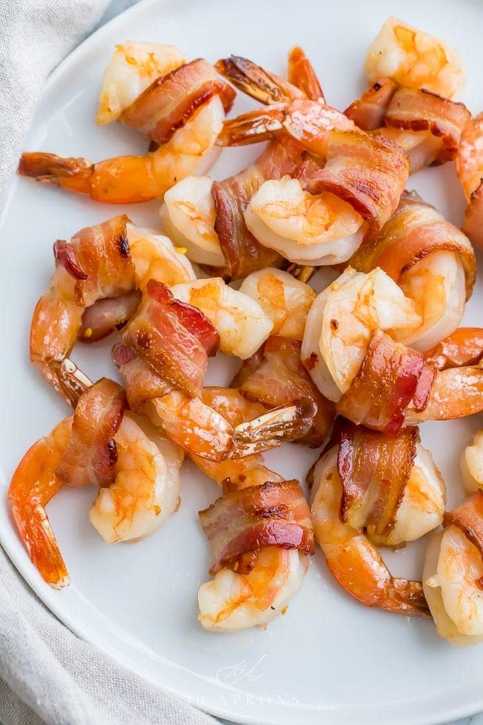 Bacon wrapped shrimp on a white plate