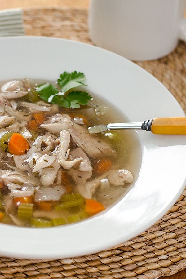 Whole30 chicken soup served in a white bowl