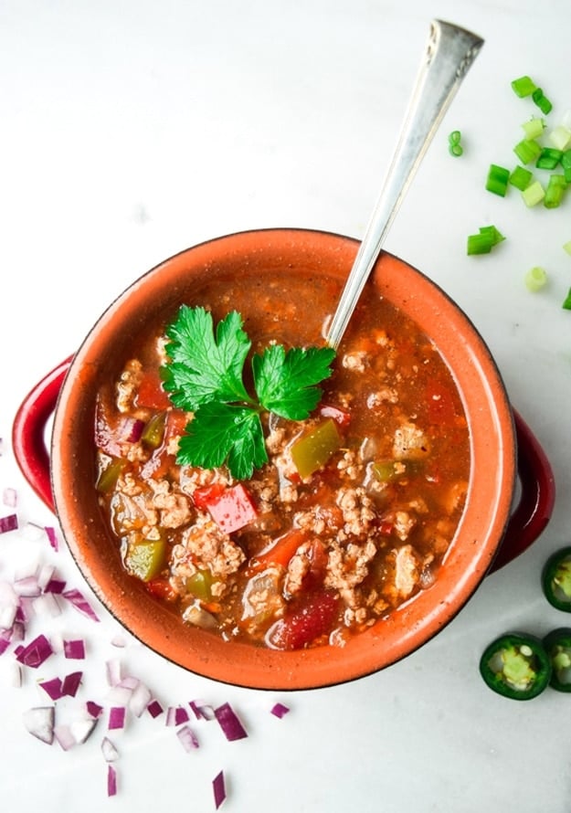 Slow cooker whole30 chili served with fresh herb garnish