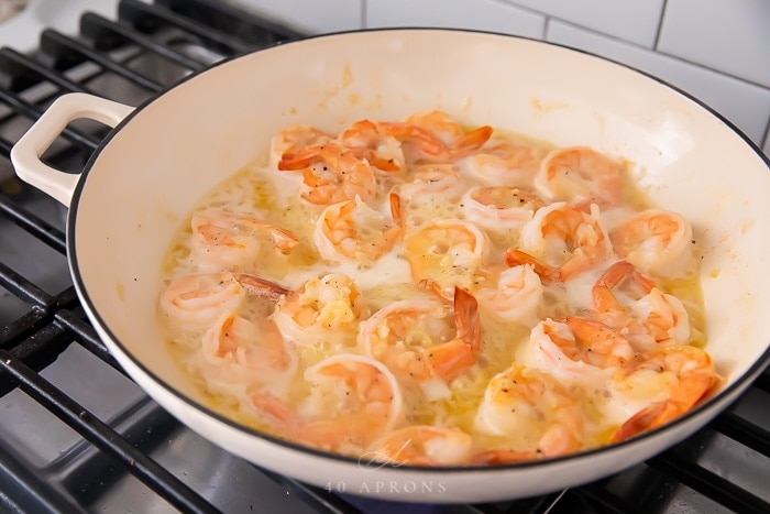 Garlic butter shrimp being cooked in a skillet