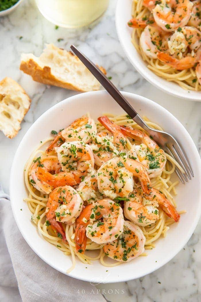 Shrimp with pasta served in a bowl with a fork