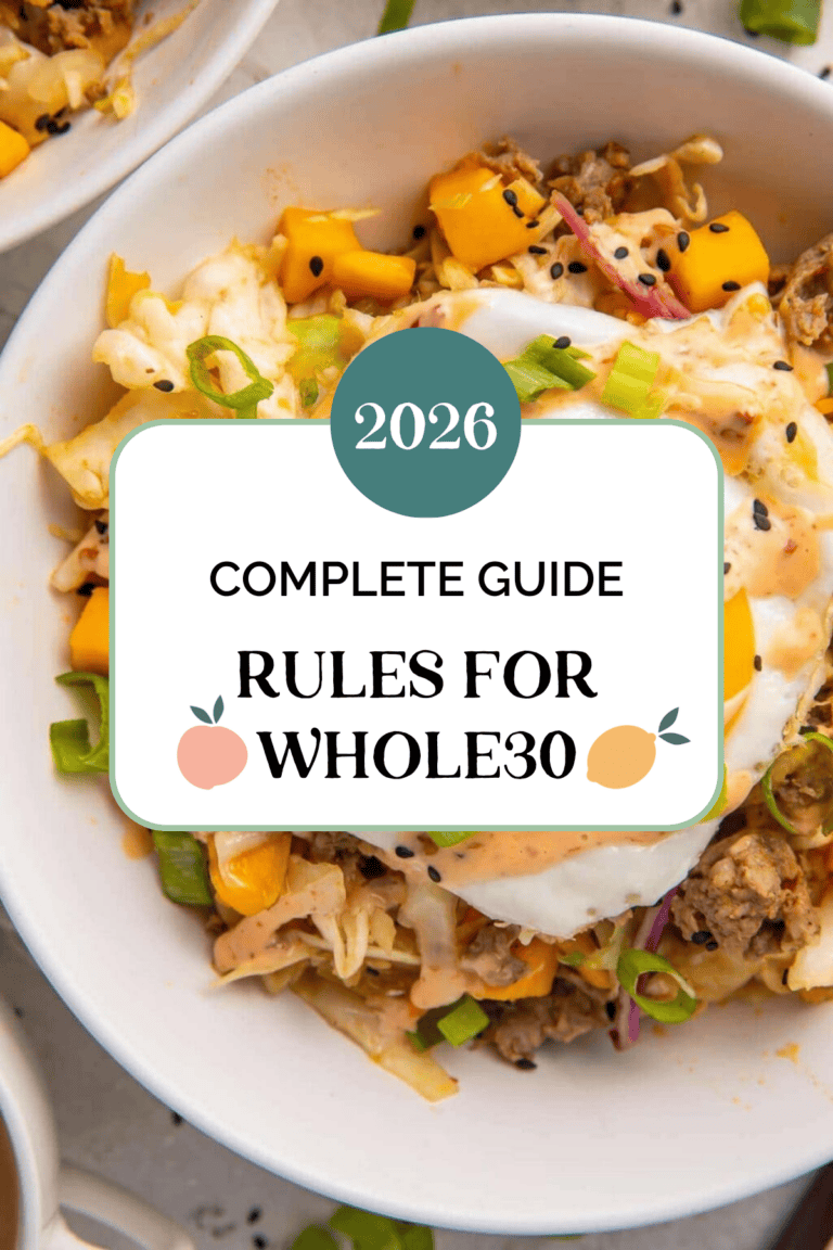 Overhead view of a Whole30 bowl with ground meat, fried egg, mango, cabbage, and green onions.
