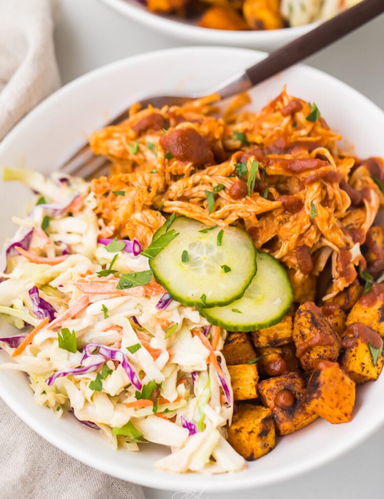 BBQ chicken bowl with sweet potatoes and coleslaw in a bowl