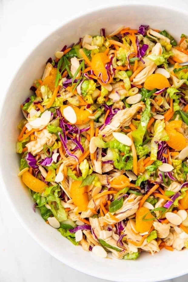 Overhead angle of part of a white bowl containing Chinese chicken salad