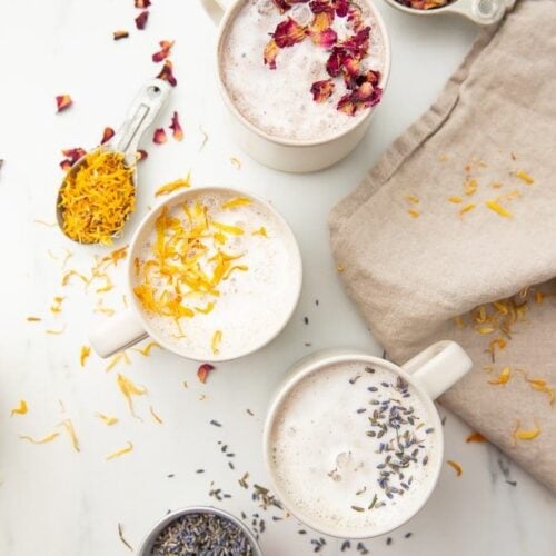 Three versions of moon milk in white mugs