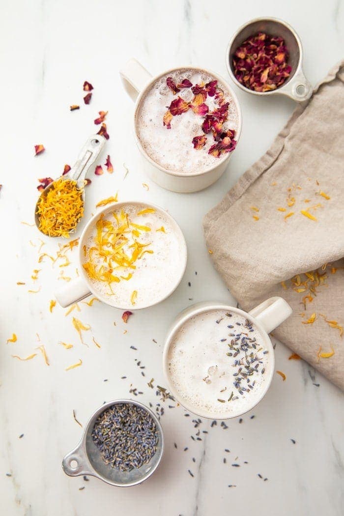 Three versions of moon milk in white mugs