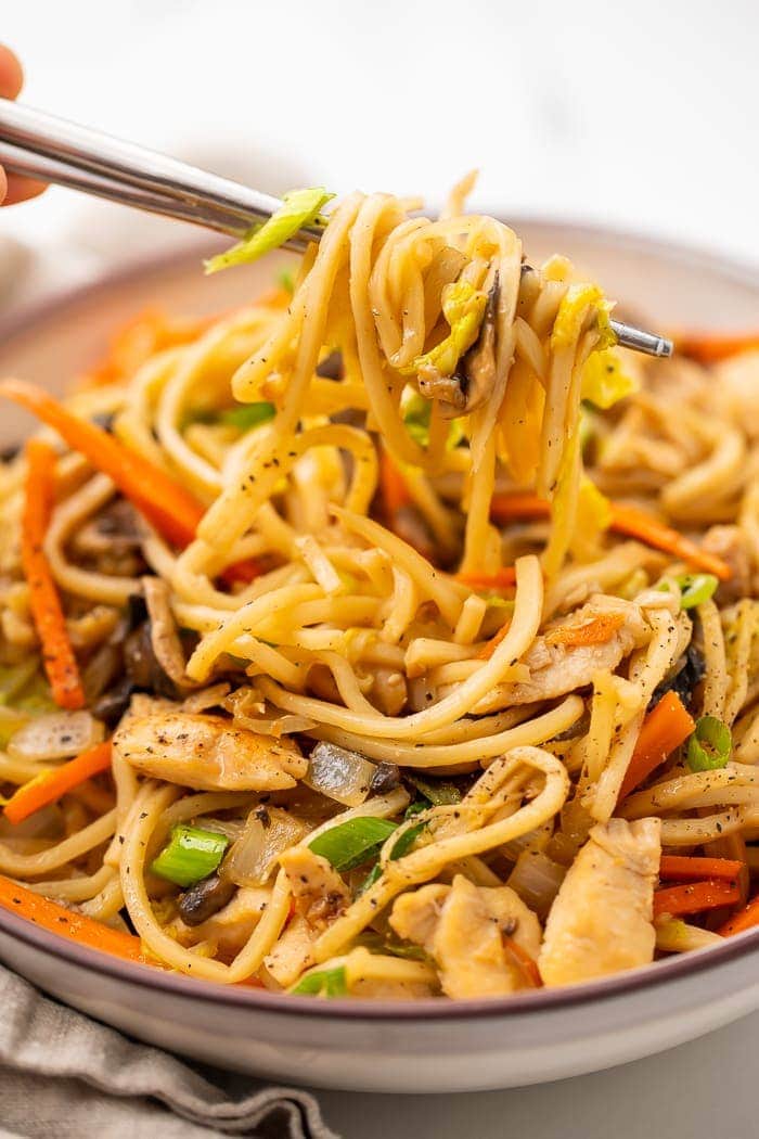 Whole30 chicken lo mein in a bowl with two chopsticks