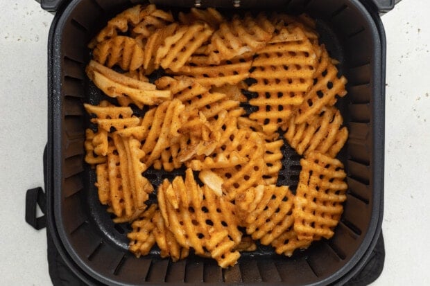 Frozen waffle fries in air fryer basket