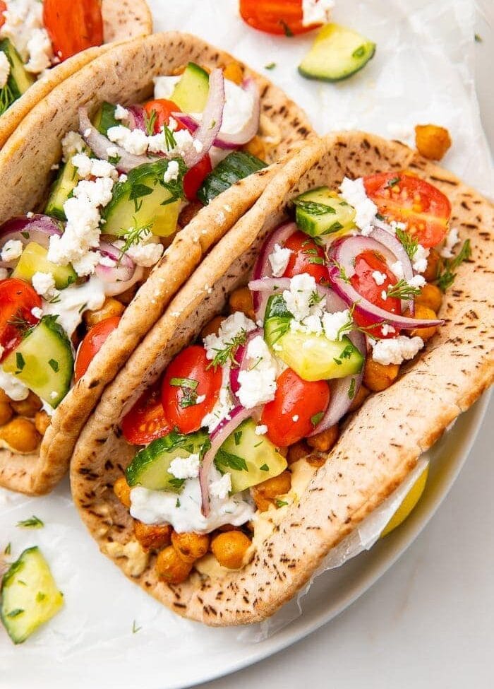 Two chickpea gyros on a white plate