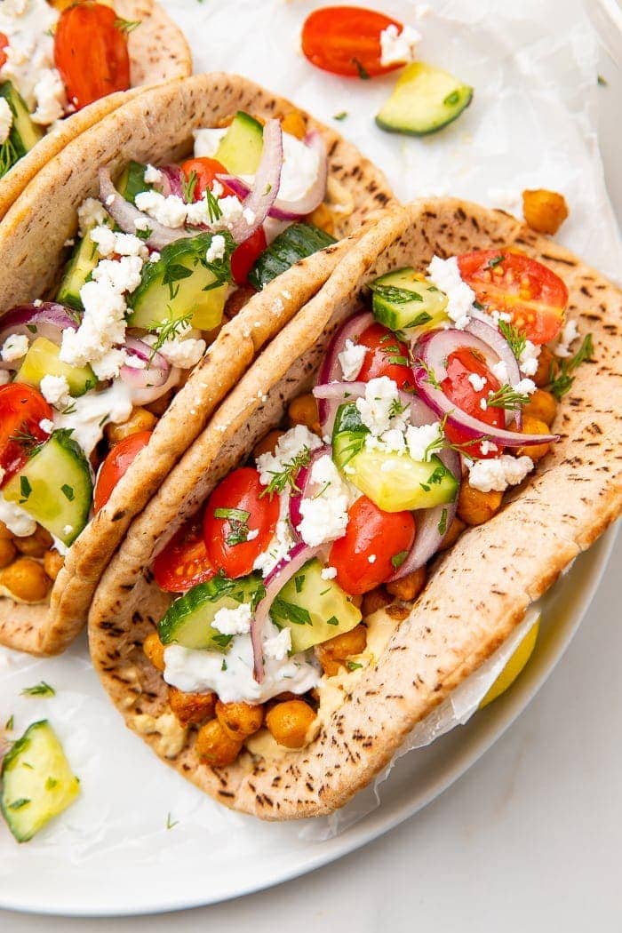 Two chickpea gyros on a white plate